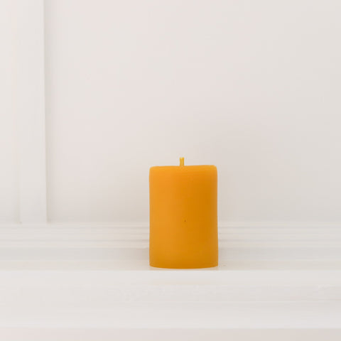 The Classic Collection Beeswax pillar-Small. Burn-time of up to  28 hours. 6.5cm wide, 9cm high. weighs 200g. All measurements are done at a minimum.